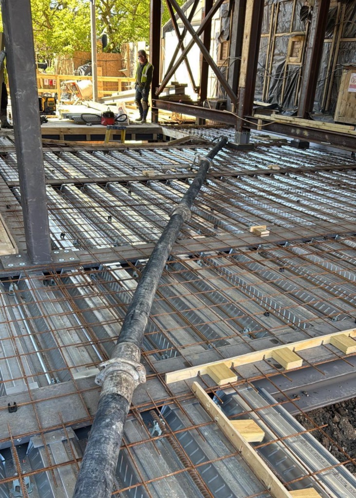 A King Concrete Pumping line pump feeding concrete on site near Kingston